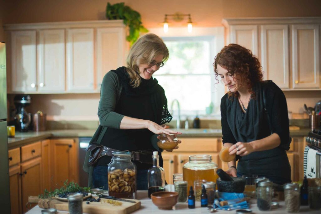 Jeannine Buscher and Sarah Schomber of Buchi, make kombucha in the kitchen. Mountain BizWorks